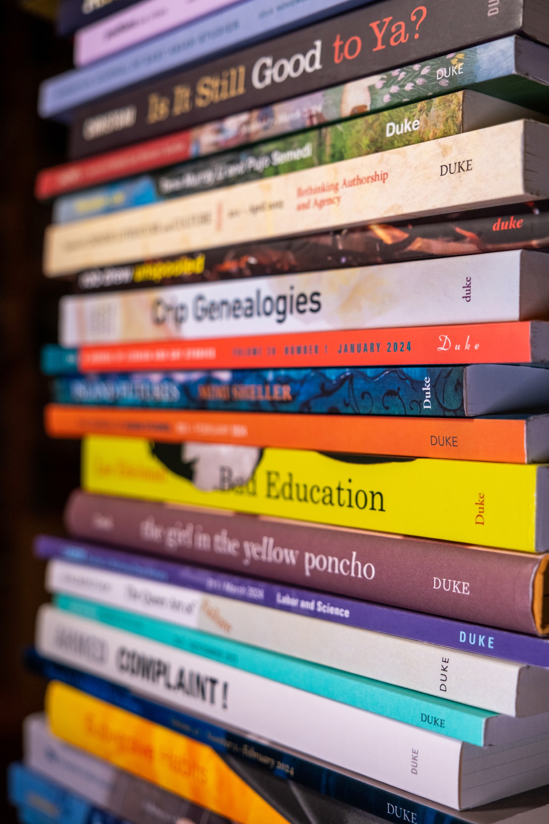 Spine-side view of stacked books.