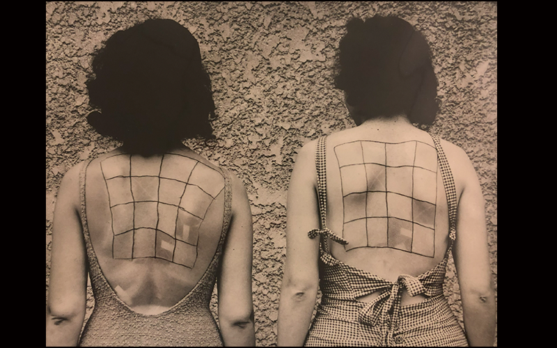 two women in swimsuits with squares on their backs