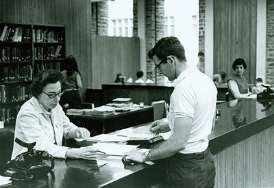Photo of librarian helping a student