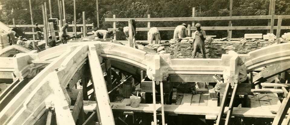 Photo of construction workers working on the roof of the Duke Chapel
