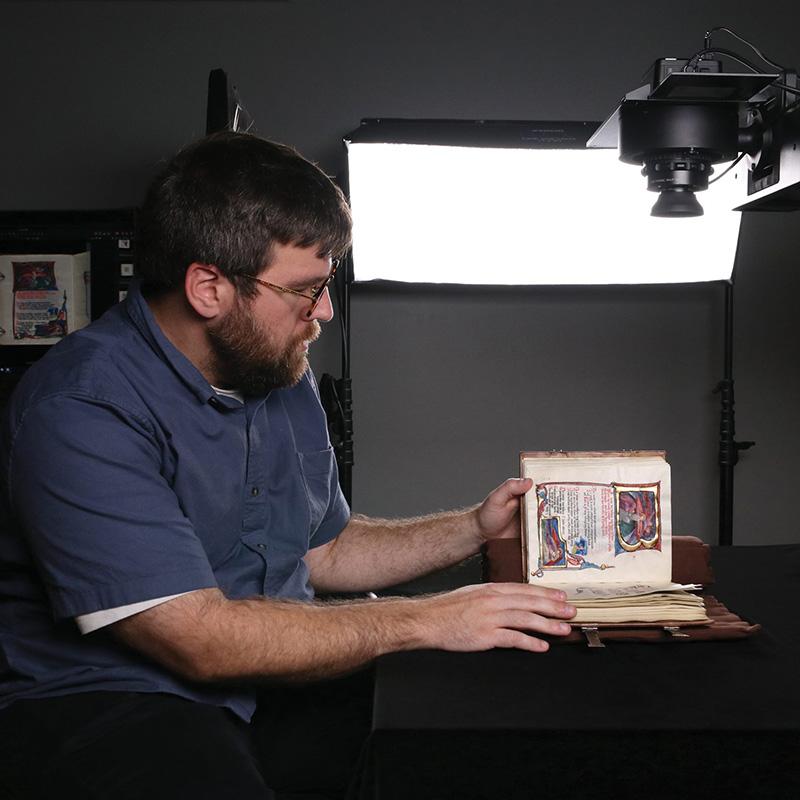 librarian preparing a rare book for digitization