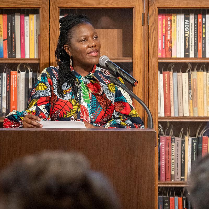 woman speaking at library podium