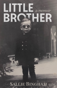 Cover image from the book titled Little Brother, a Memoir. It is an image of a male child wearing a jacket and dark glasses.